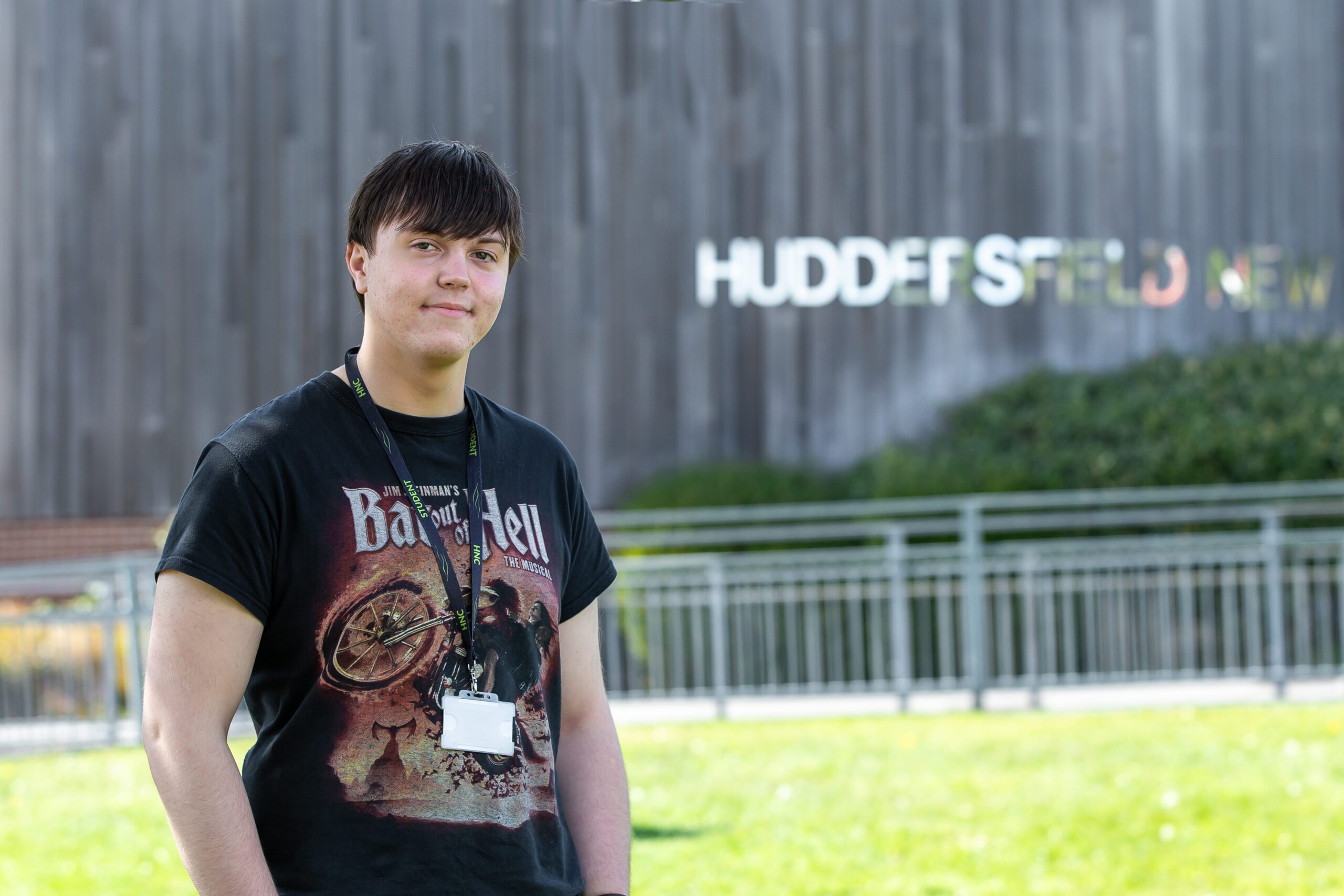 Picture of student in front of College building